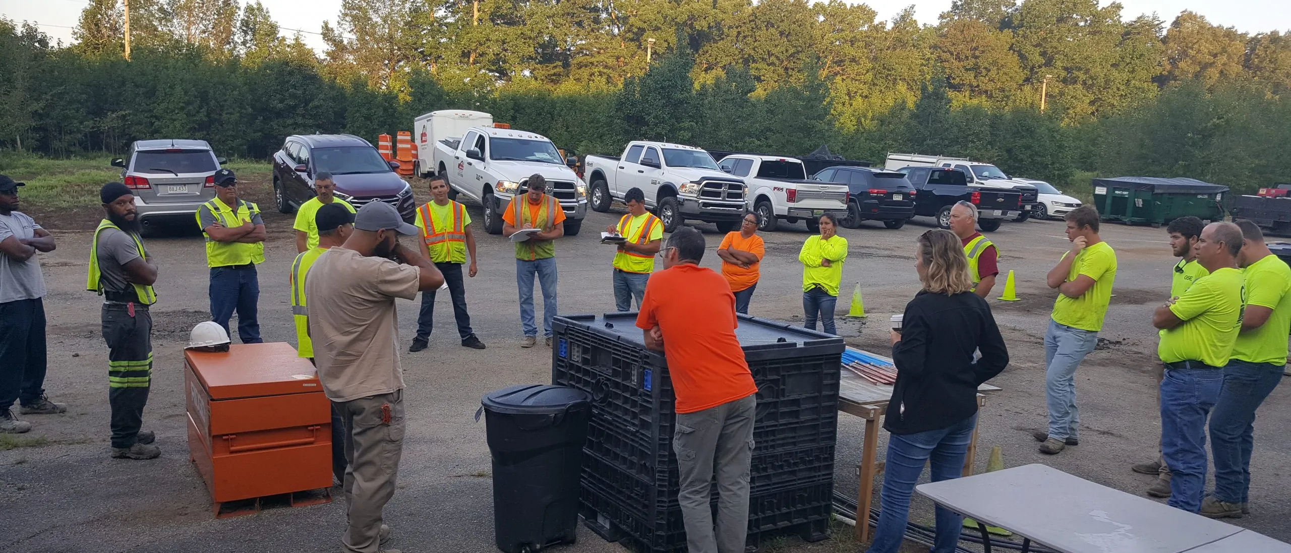 Employees gathered outdoors for a team meeting