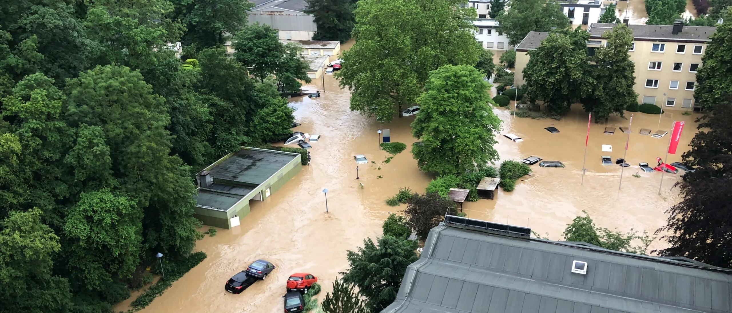 Aerial view of a flooded neighbourhood with water surrounding the houses