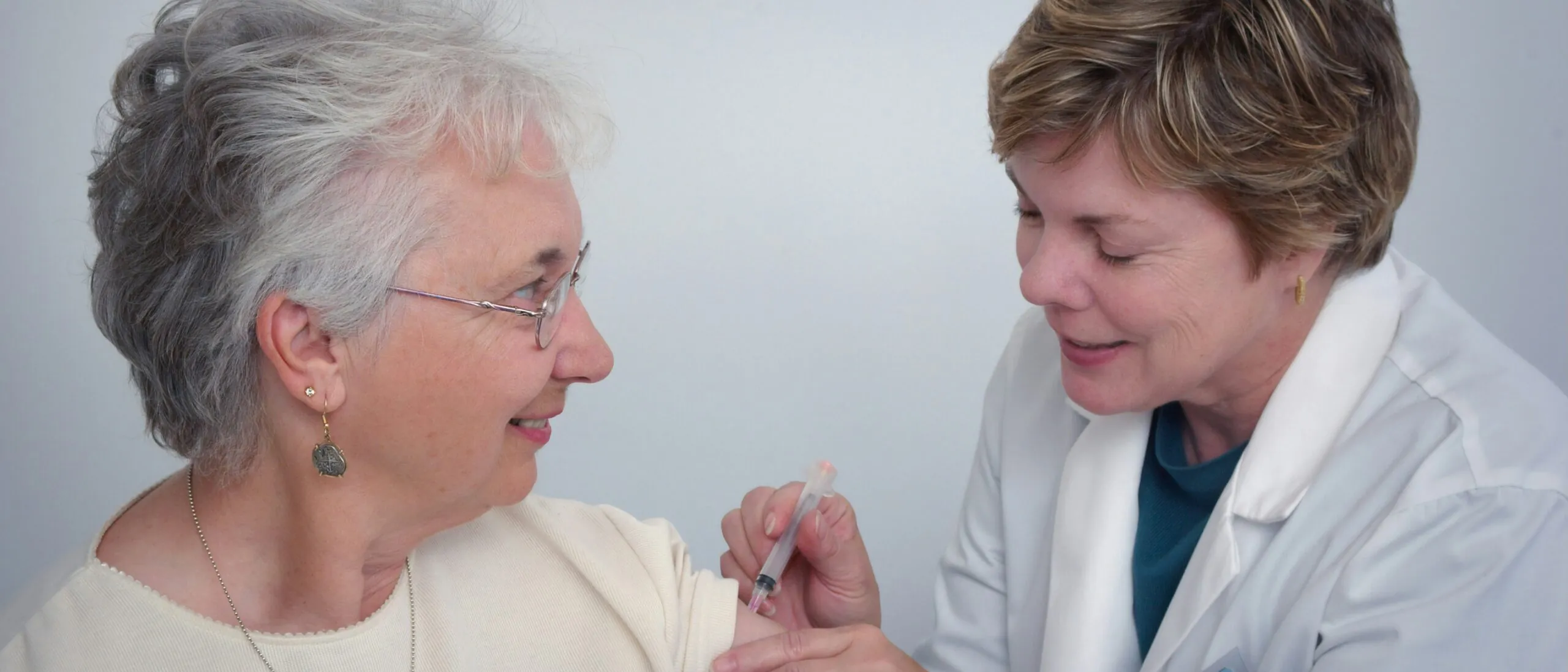 Home health nurse checking an elderly client’s blood pressure at home