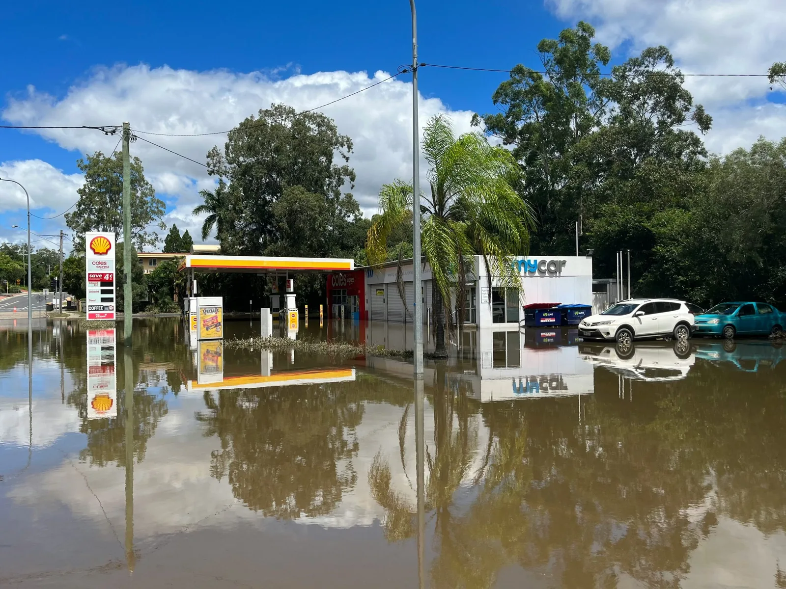 Floodwater standing across a road and a service station forecourt
