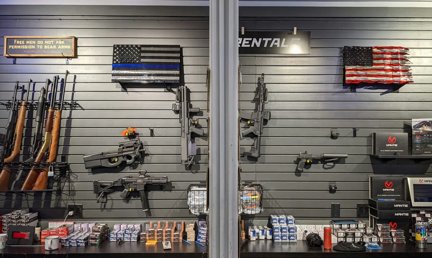 Firearms displayed on a wall inside a gun shop