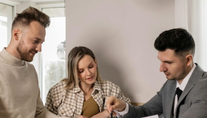 3 people looking at plans