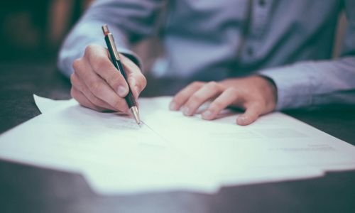 person writing on paper