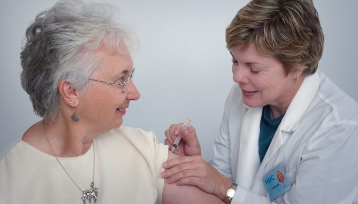 nurse giving elderly woman a shot