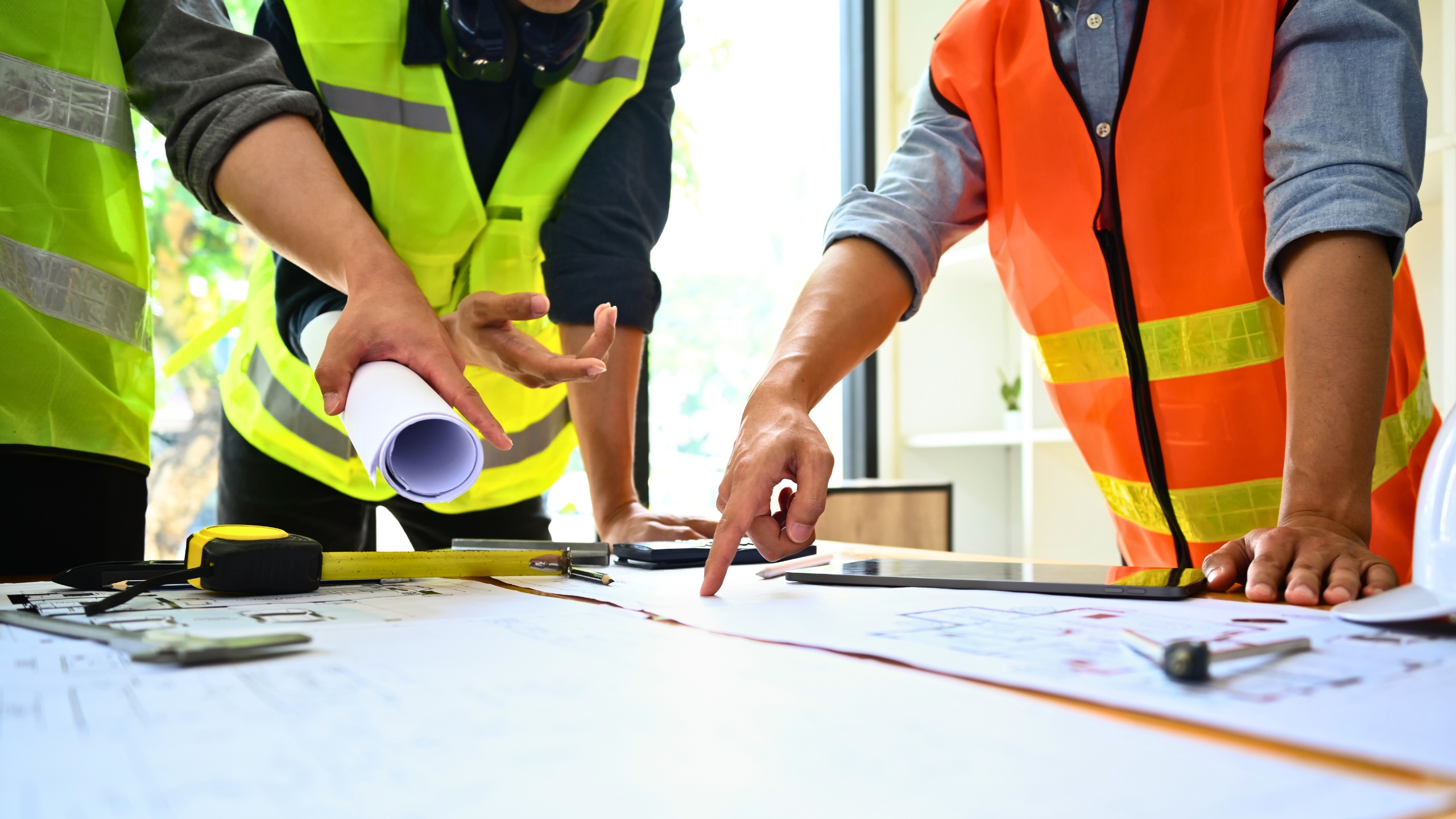 construction workers looking at a set of plans
