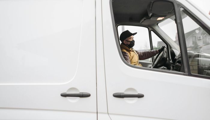person driving a white van